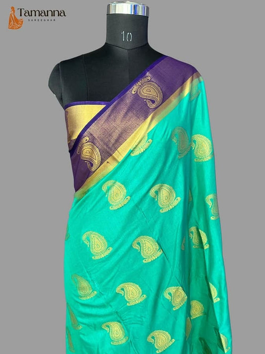 Turquoise silk saree with diagonal purple pallu border and gold paisley zari