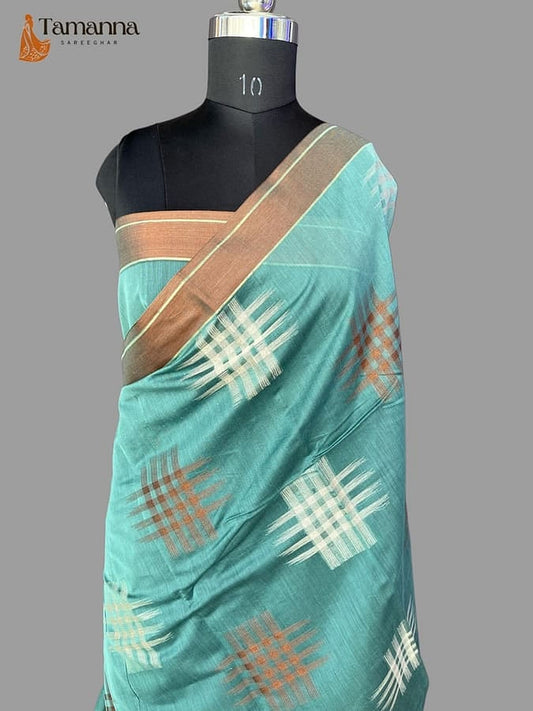 Turquoise silk saree with diagonal pallu and gold-brown woven border, checked motifs