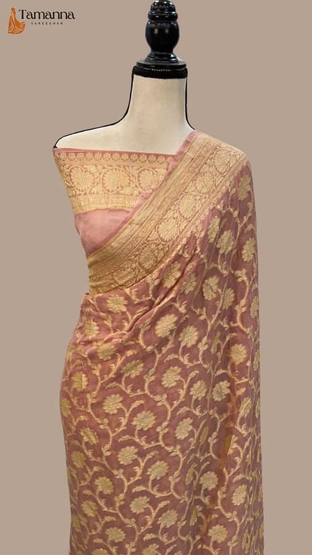 Peach pink and gold Banarasi saree with allover floral motifs, draped on mannequin