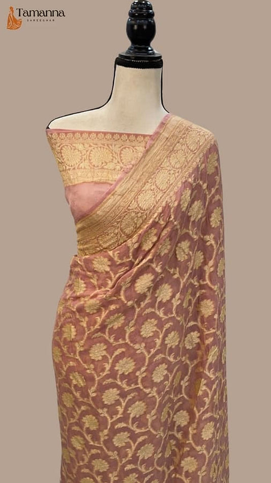 Peach pink and gold Banarasi saree with allover floral motifs, draped on mannequin