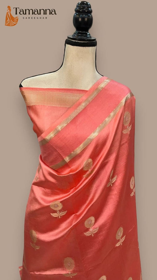 Coral pink saree drape with gold zari border and floral motif panel