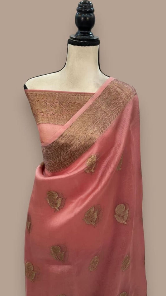 Peach Banarasi handloom saree on mannequin, gold border and leaf motifs, draped over shoulder