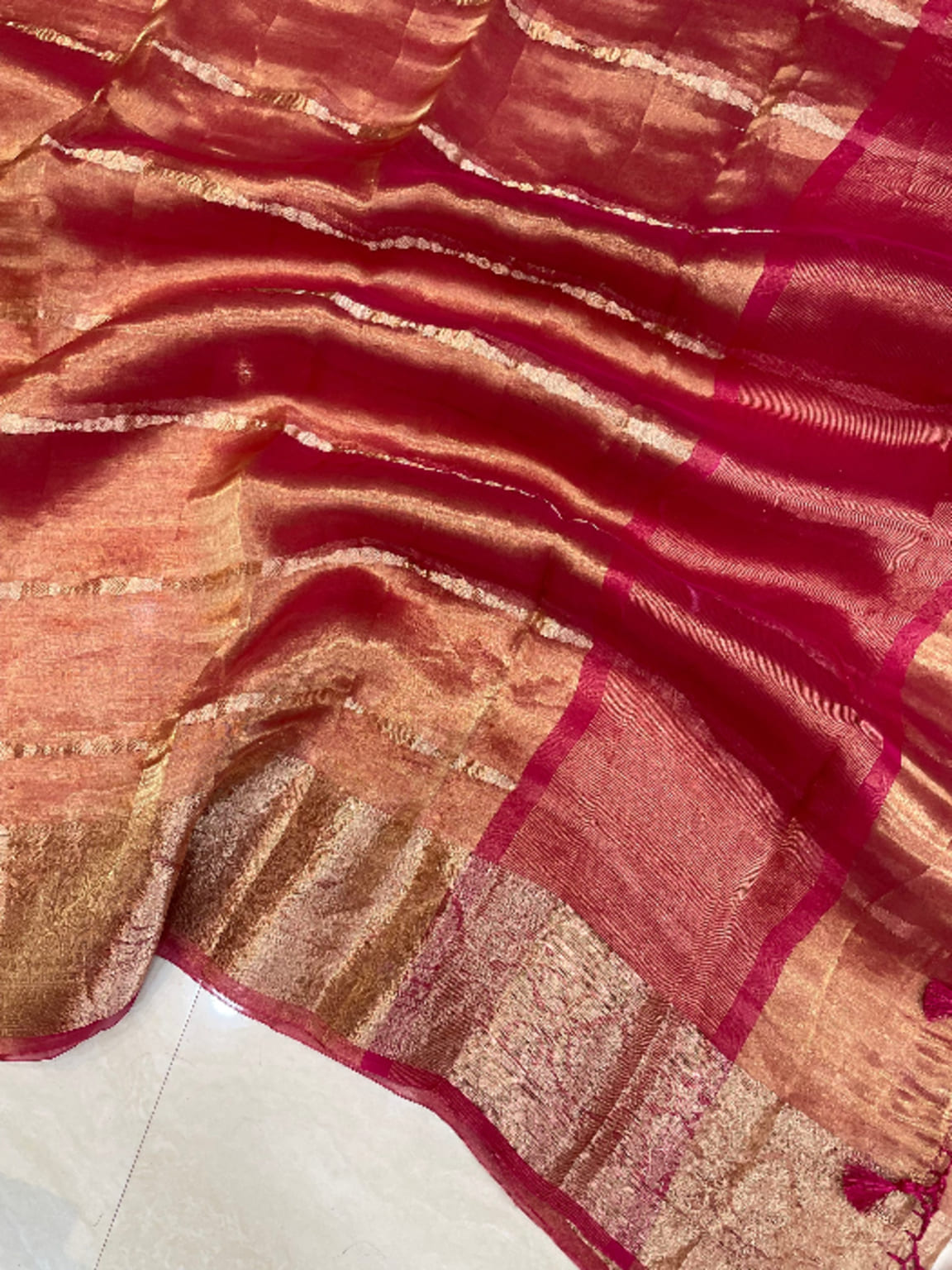 Peach and maroon Banarasi tissue fabric with gold stripes and textured sheen
