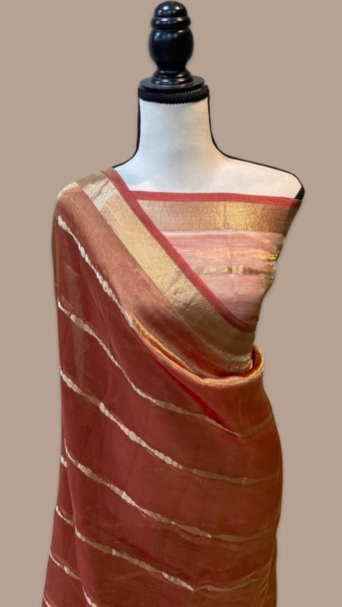 Peach Banarasi tissue saree on mannequin, maroon border and gold-woven stripes