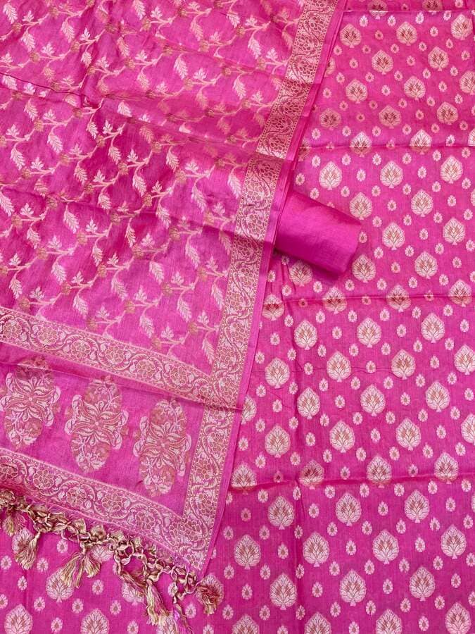 Pink woven border with butti pattern and tassel trim on tussar silk fabric
