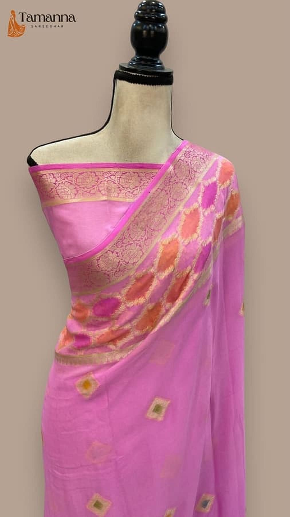 Pink chiffon saree draped on mannequin, gold-trimmed pallu with geometric motifs