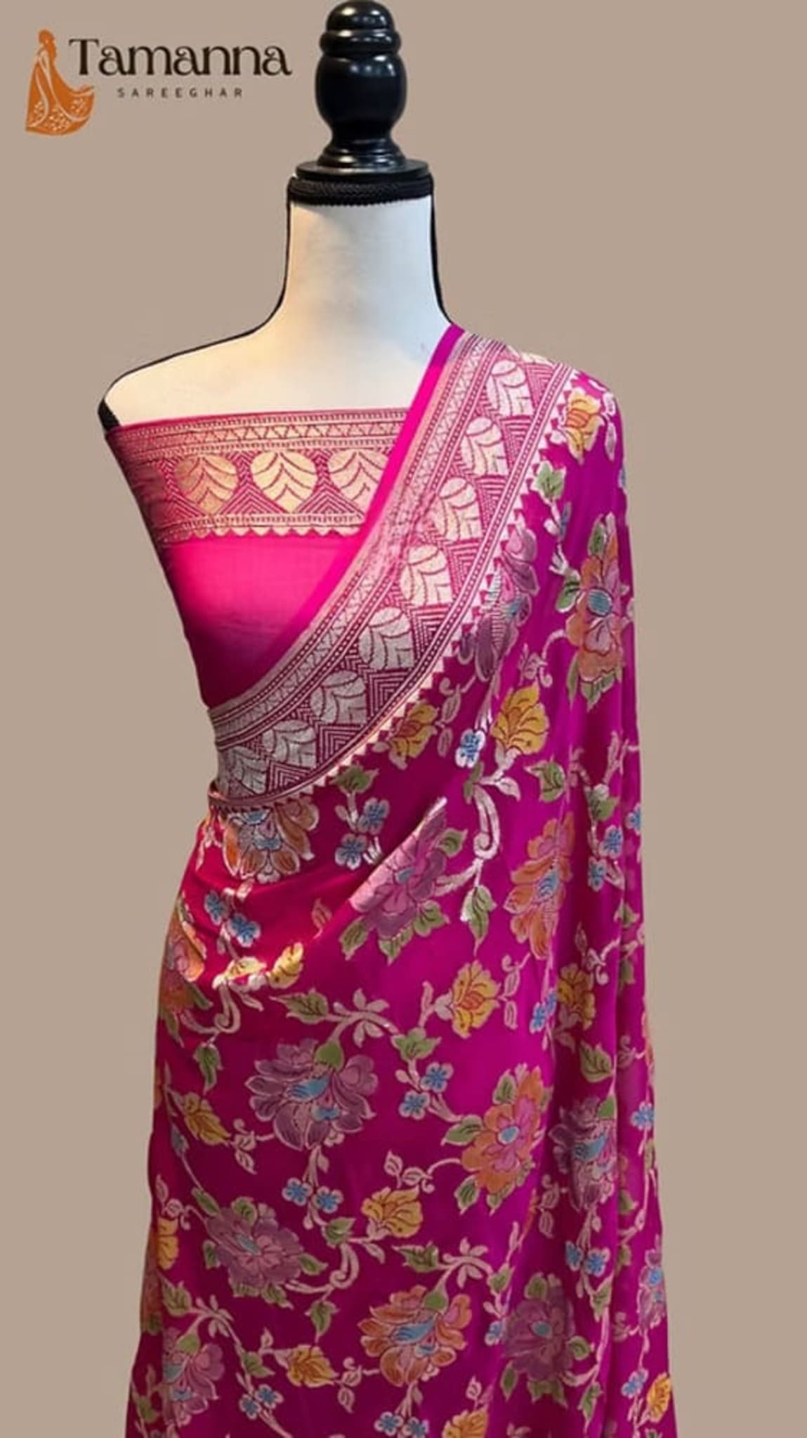 Magenta saree on mannequin with multicolor floral prints and wide contrast zari border
