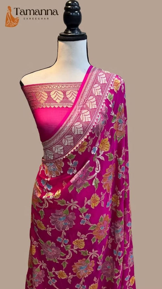 Pink saree draped on mannequin with contrast blouse and patterned pallu zari border