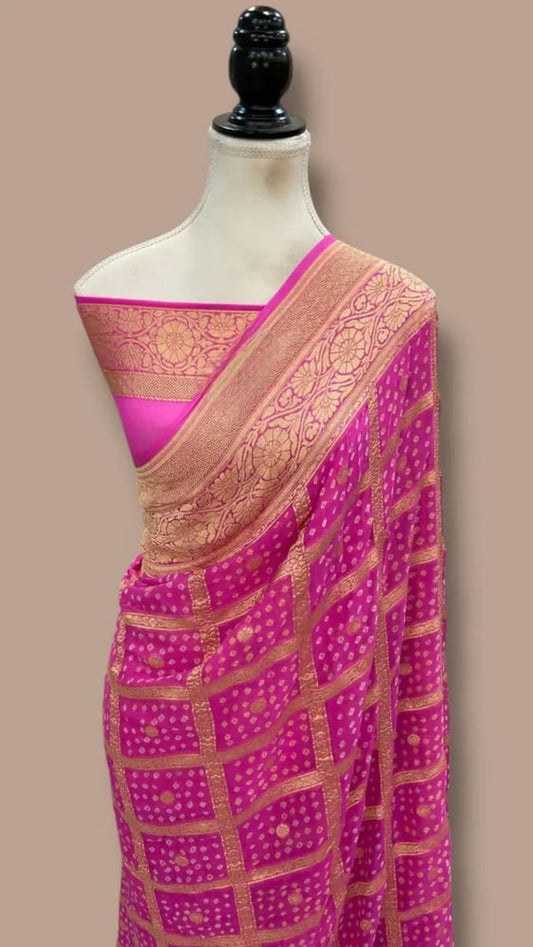 Purple saree drape with pink bandhej sections and gold trim on the pallu