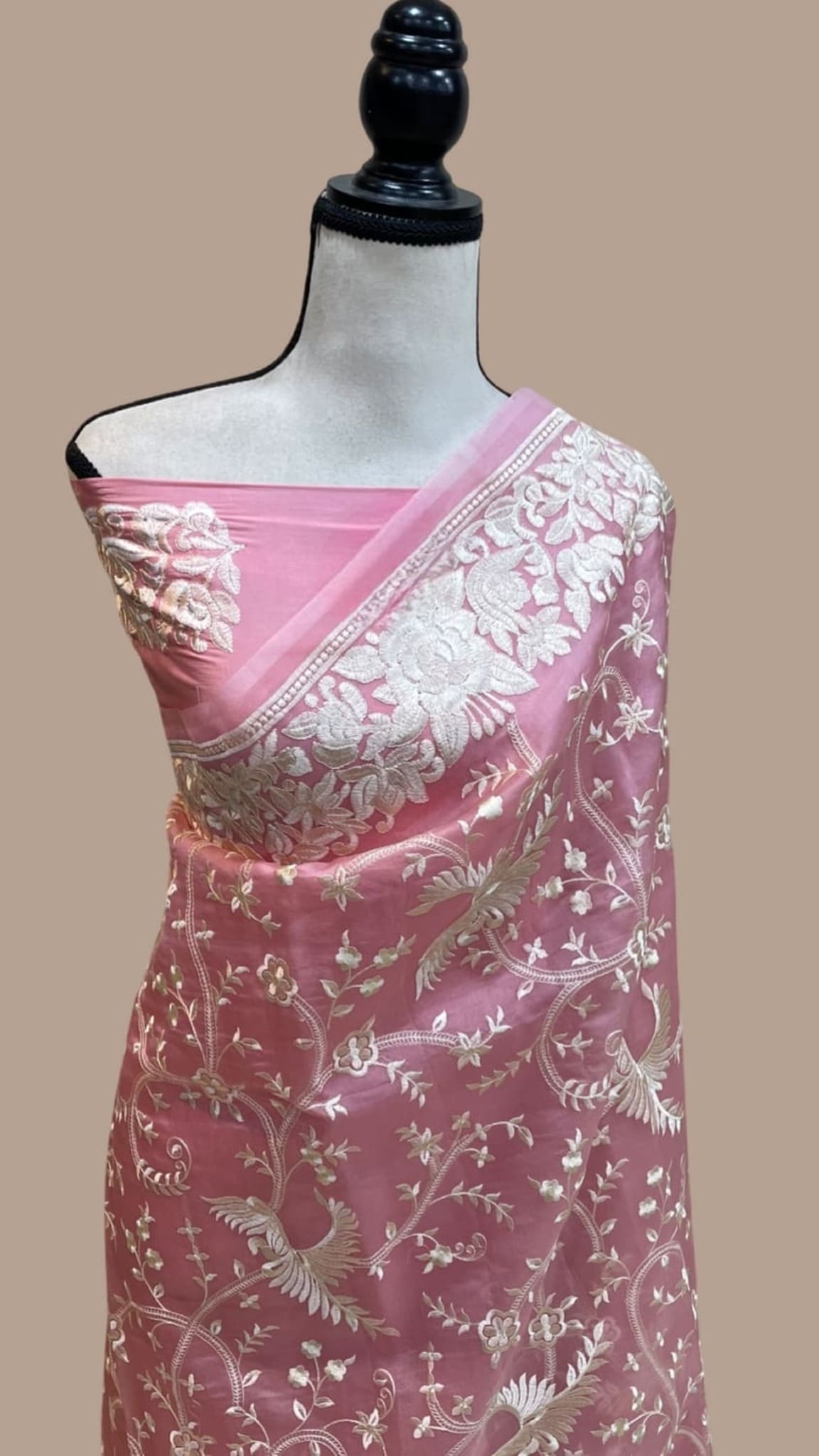 Pink organza saree drape with pink-gold floral pallu border and vine embroidery