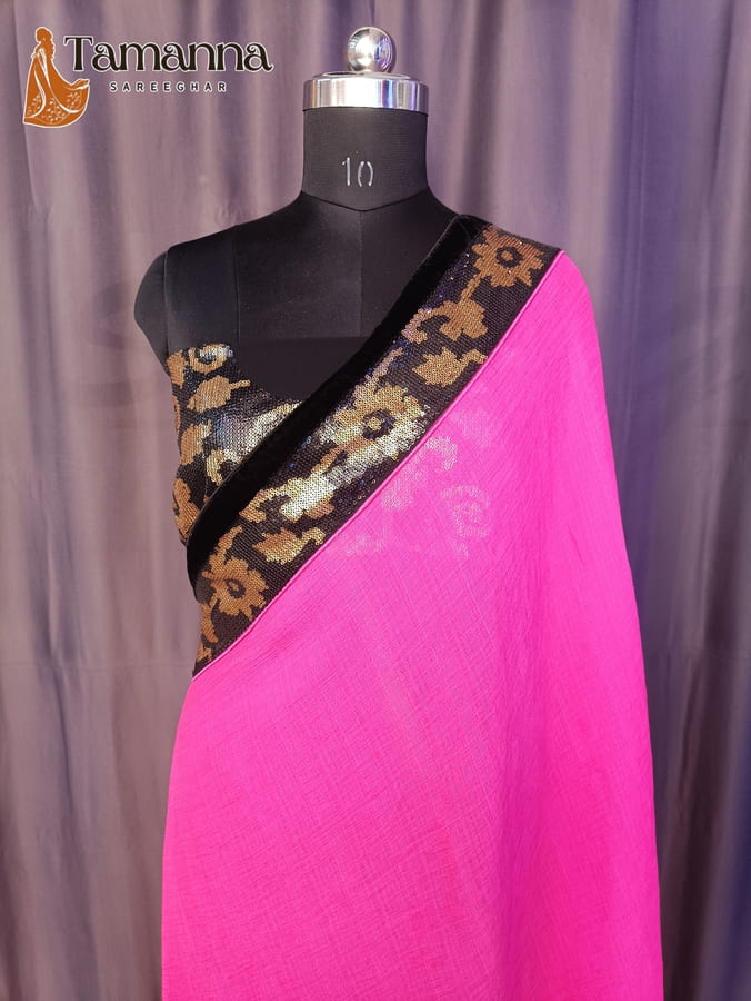 Pink chiffon designer saree with black and gold woven border