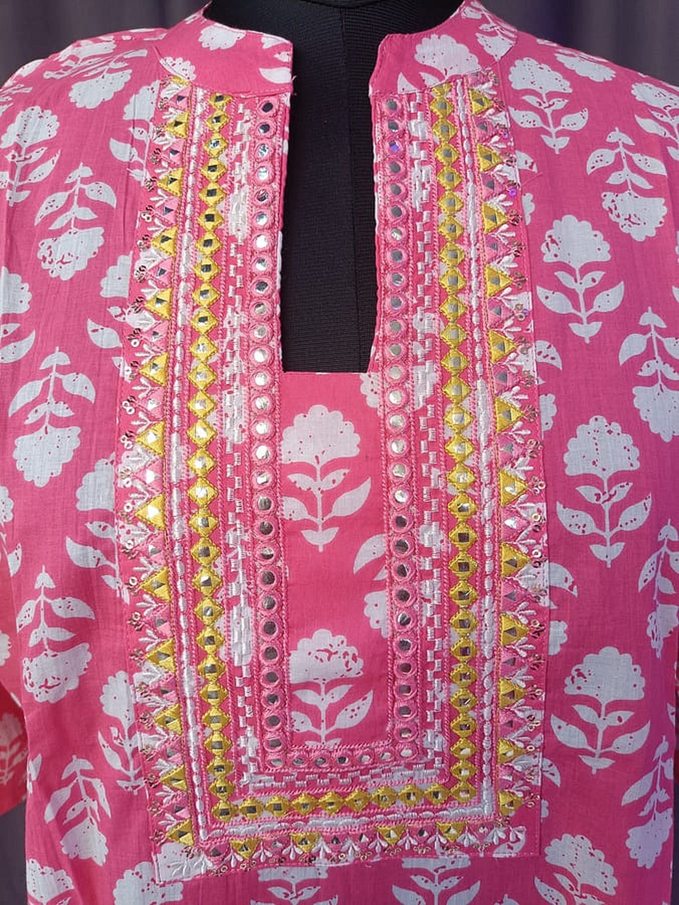 Pink printed kurta front panel detail with multicolor border and button accents