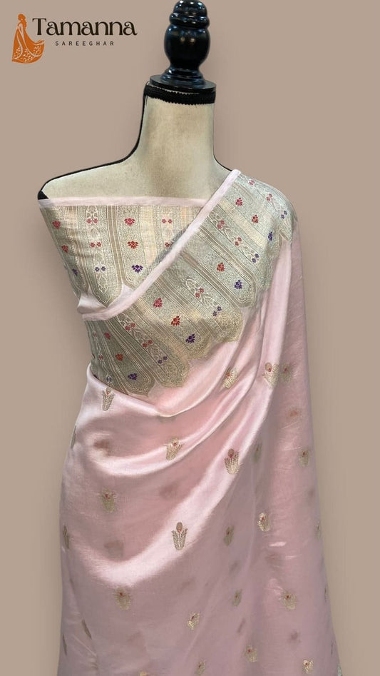 Pink silk saree on mannequin featuring gold motif print and contrasting patterned pallu