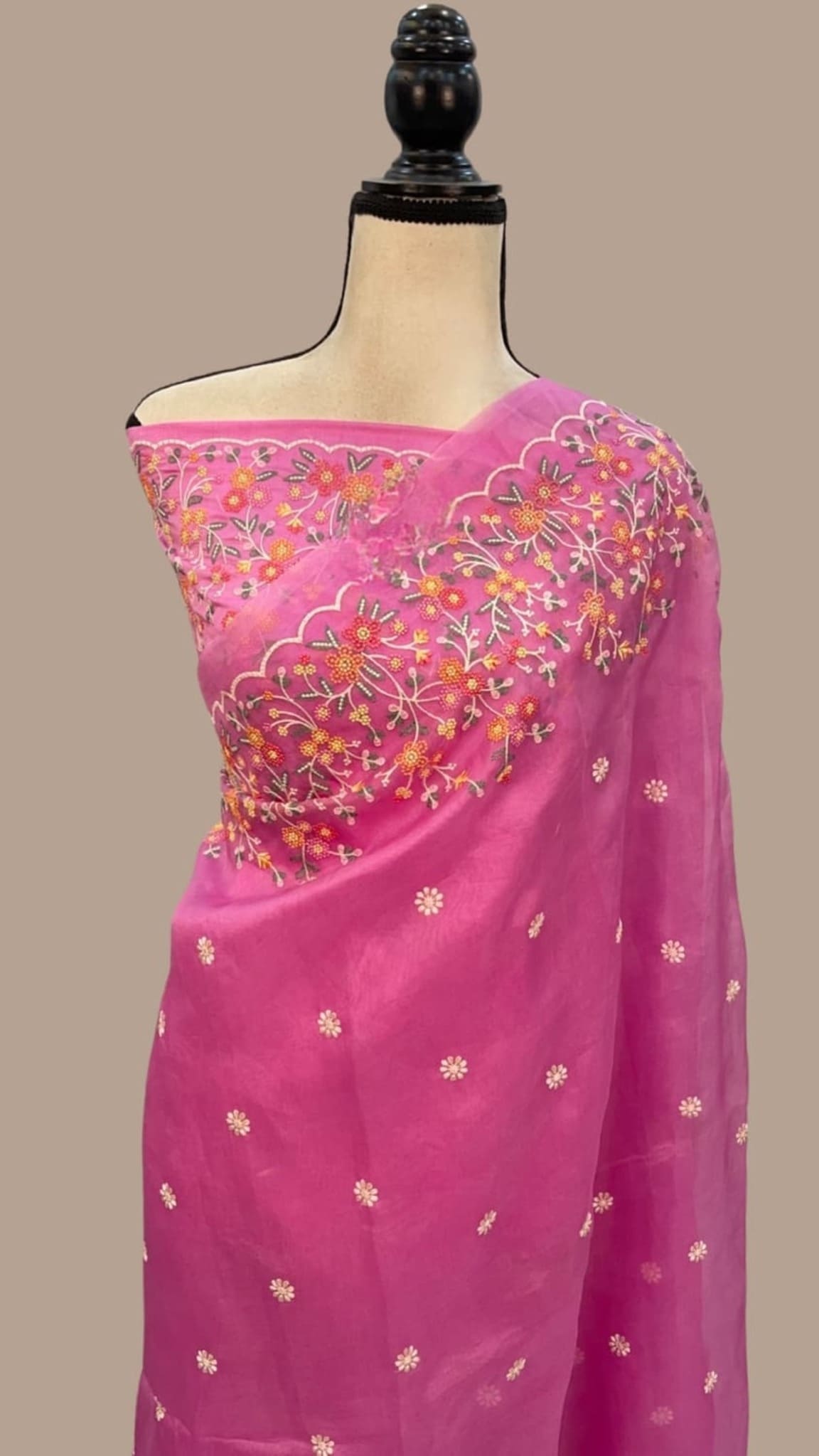 Pink organza saree drape with floral chikankari motifs and ornate pallu neckline
