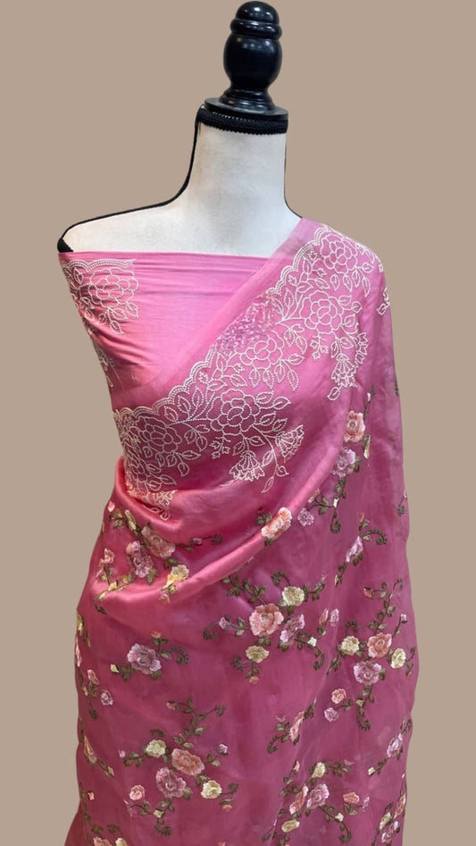 Pink organza Banarasi saree with floral embroidery and white motif pallu border