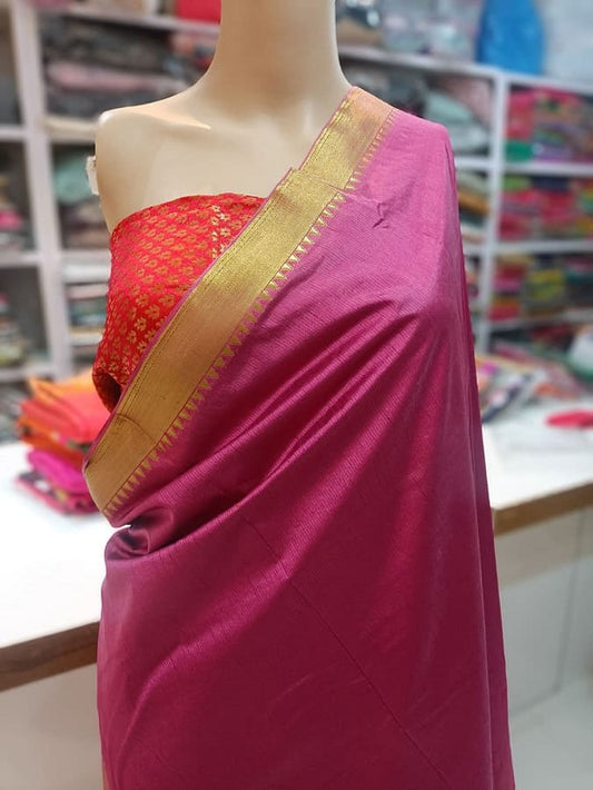 Pure silk saree draped over mannequin, magenta body with gold zari border and red blouse panel