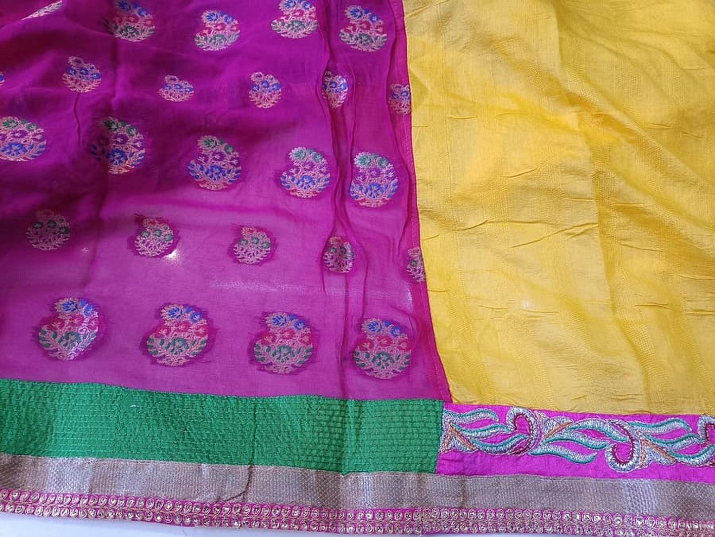 Magenta and yellow half georgette fabric with teal motifs, green strip, and purple border.