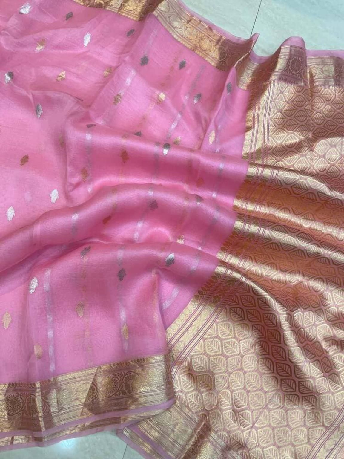 Pink Banarasi saree close-up with gold border stripe and dotted motif pattern
