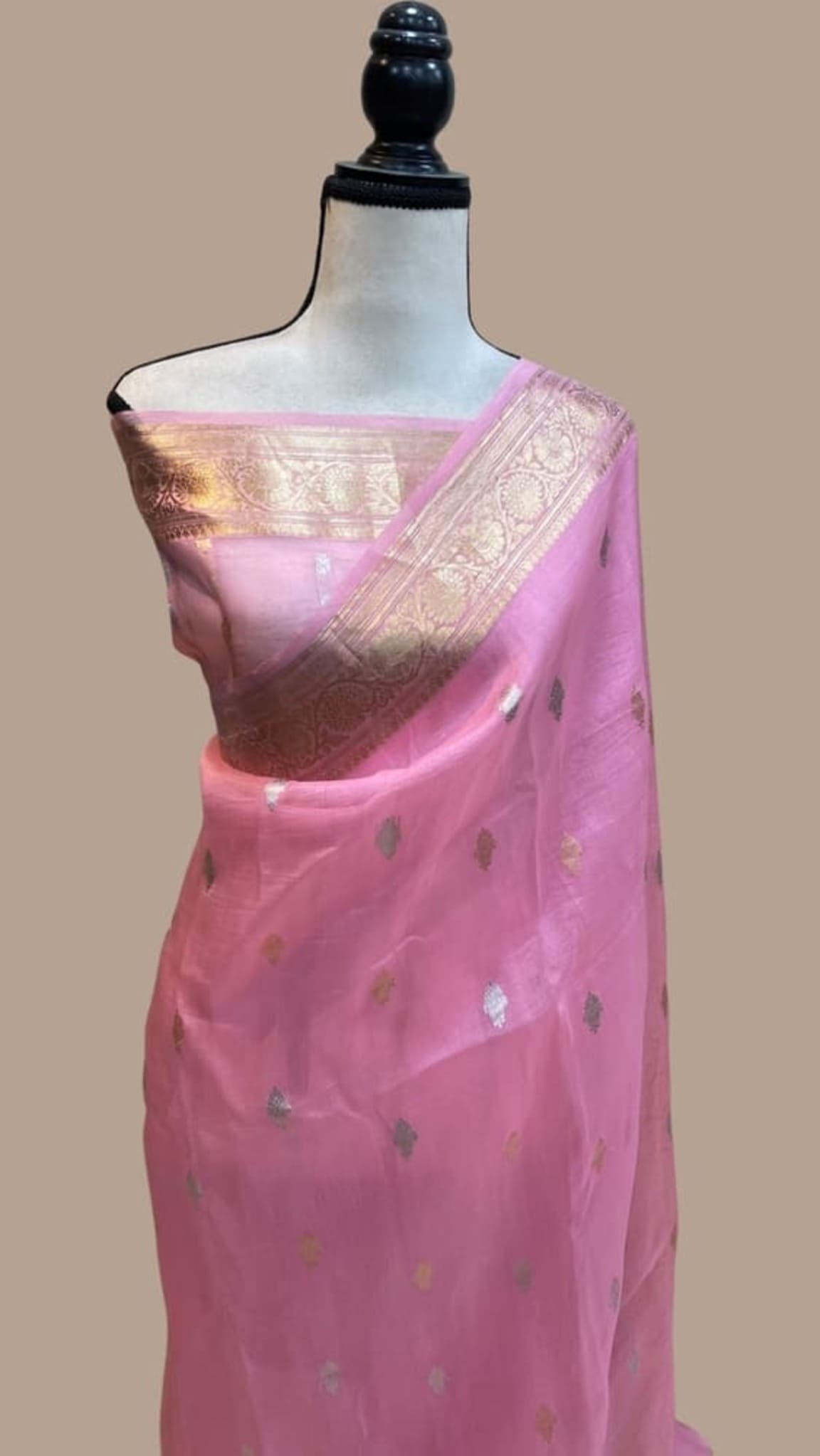 Pink Banarasi saree draped on mannequin with gold zari pallu border and motif work