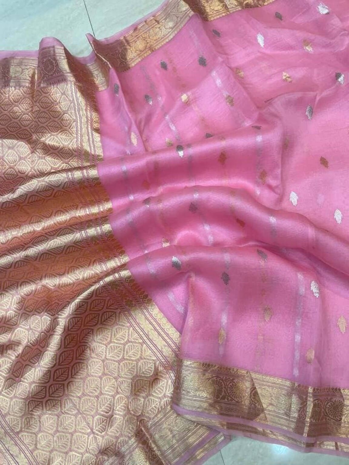 Pink saree close-up with gold zari border and small multicolor motif sprinkles on pallu