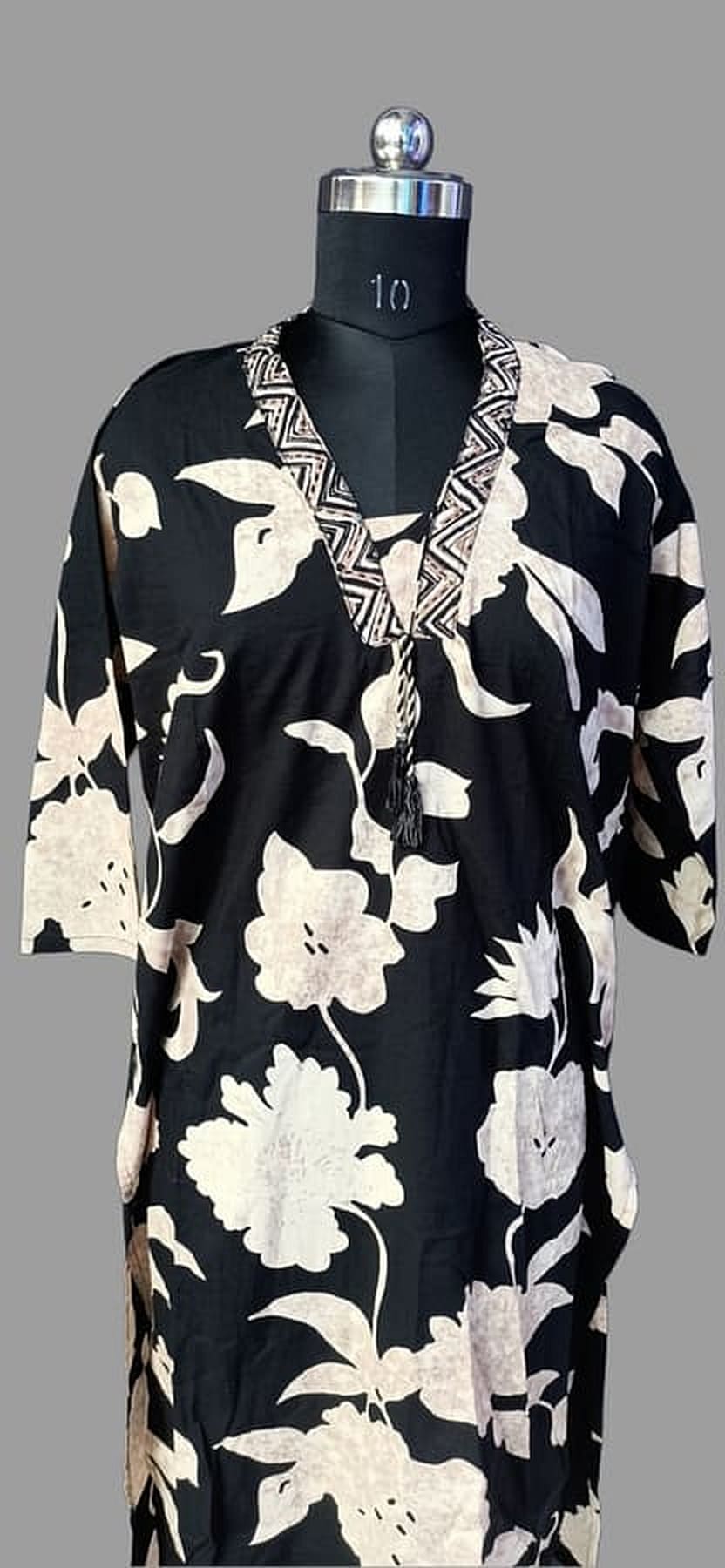 Cotton suit set kurta on mannequin front: black with white floral print and V-neck