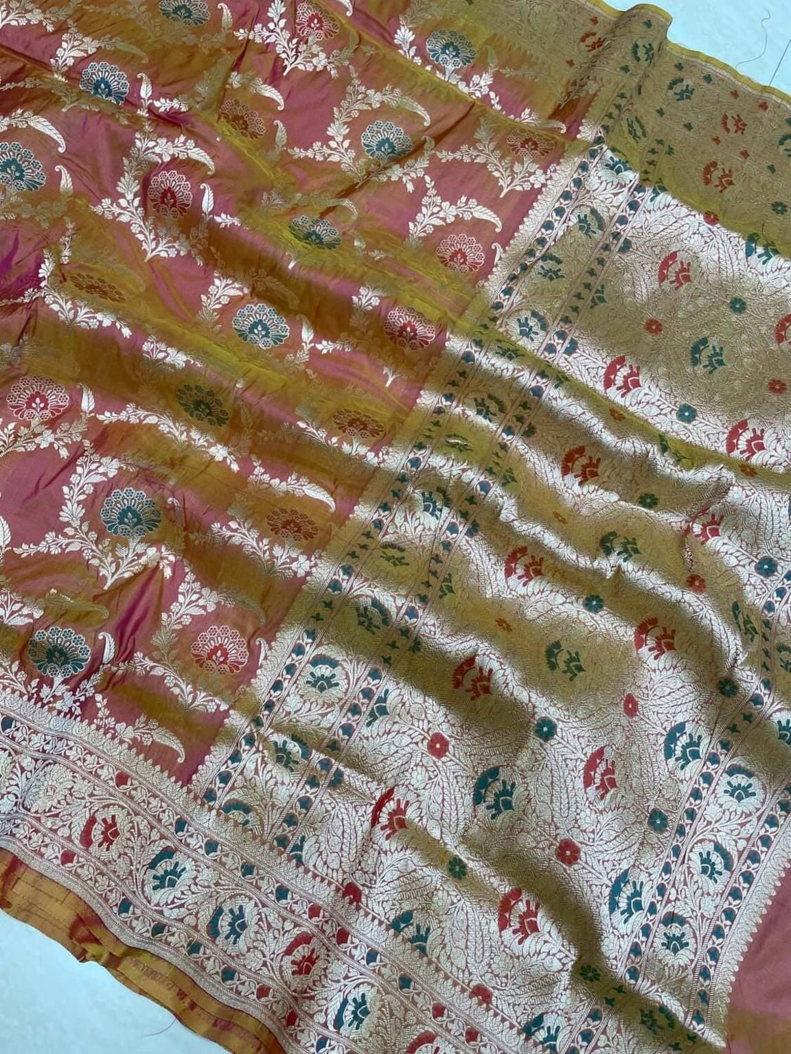 Banarasi silk saree close-up, multicolor floral jaal on golden-beige with patterned border