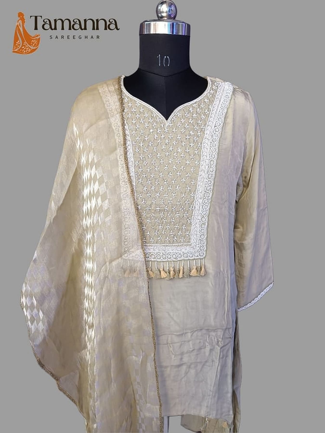 Beige embroidered kurta with V neckline and tassel trim, draped sheer dupatta