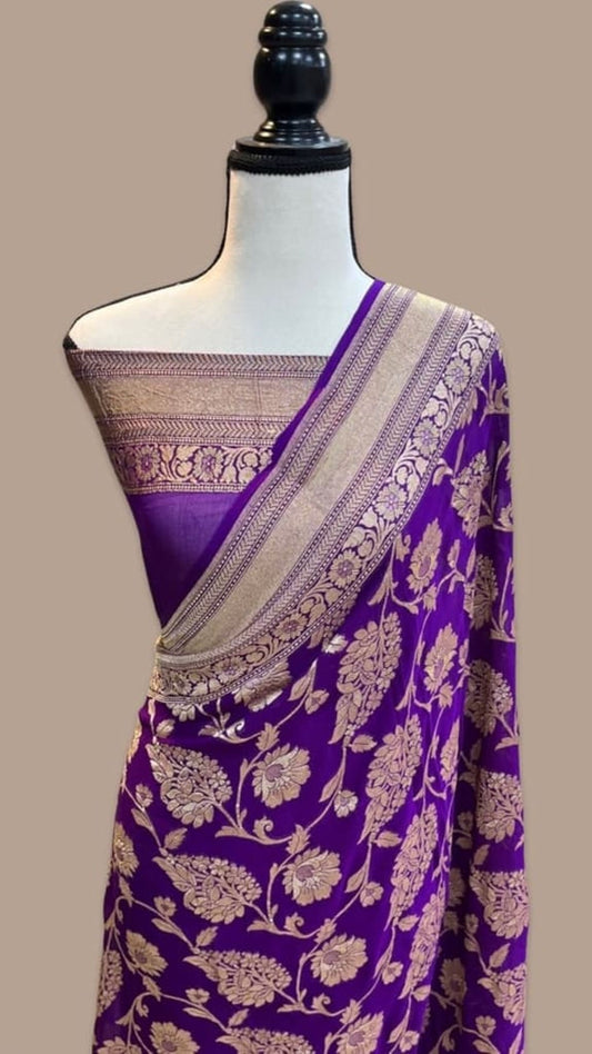Purple georgette saree drape with gold zari border and ornate floral print