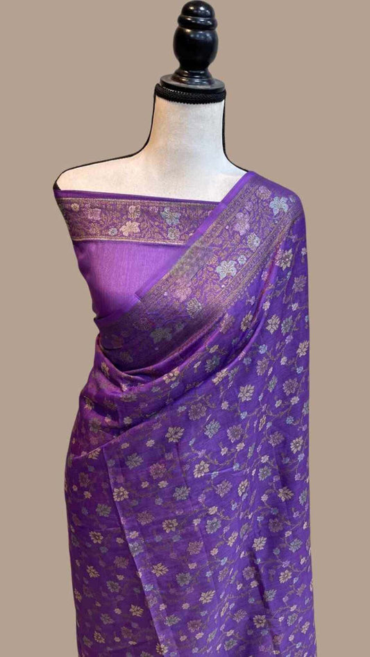 Purple crepe saree with gold floral pattern and pallu border, draped on mannequin