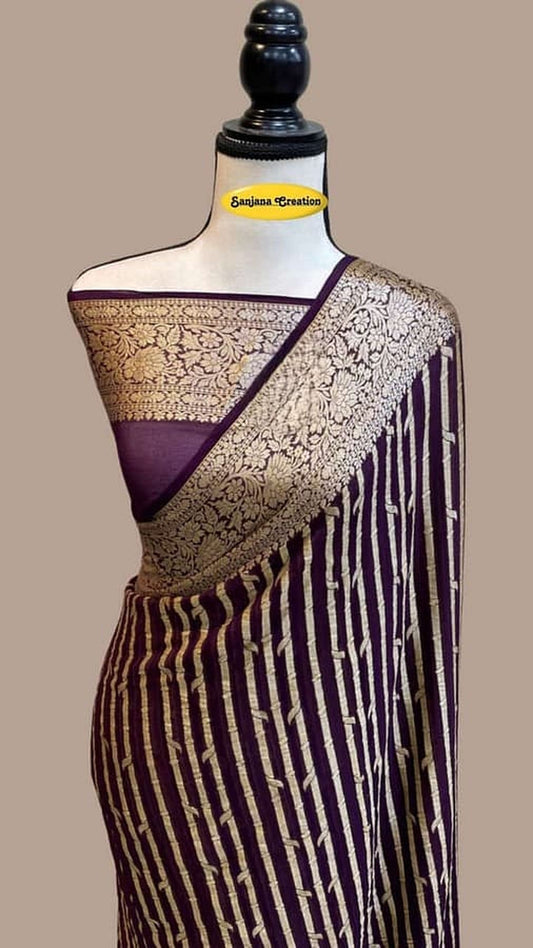 Purple chiffon handloom saree draped on mannequin, gold border and striped pallu