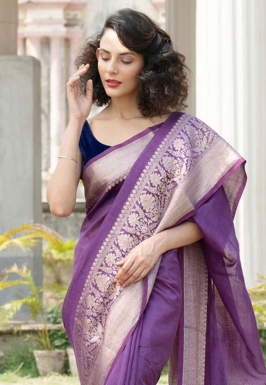 Purple linen saree with gold-toned Banarasi-style border and floral motif pallu, draped
