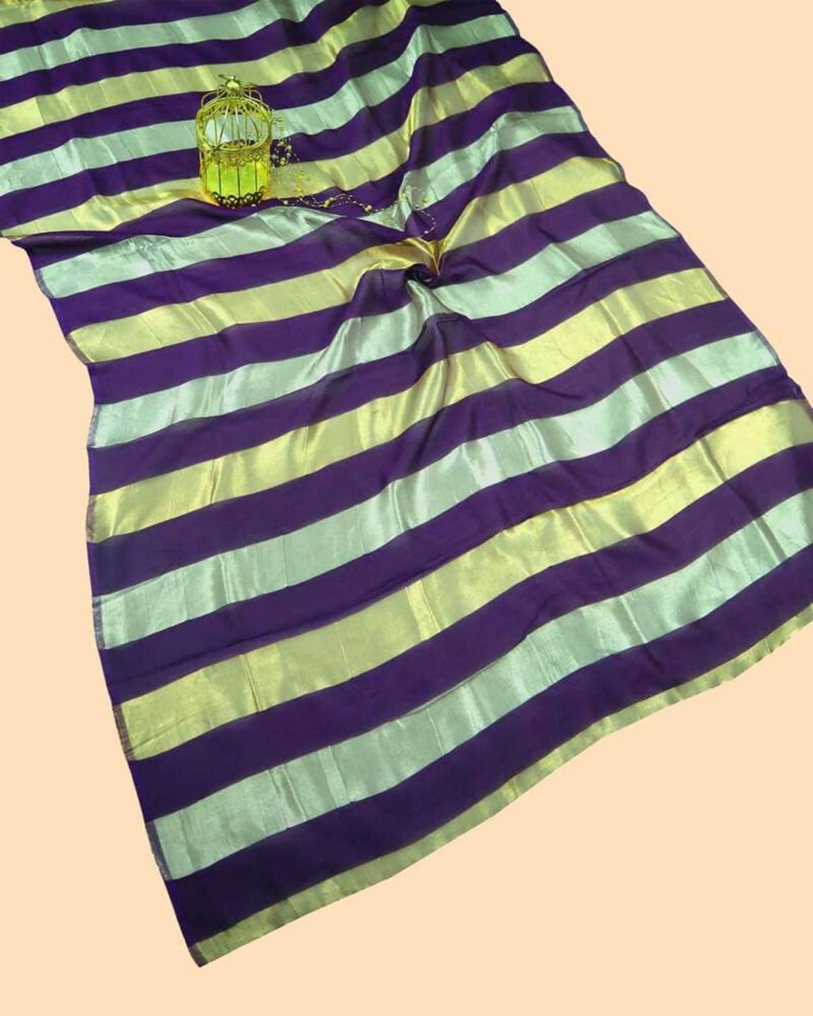 Green and purple striped tissue saree with metallic sheen, center-knot pallu