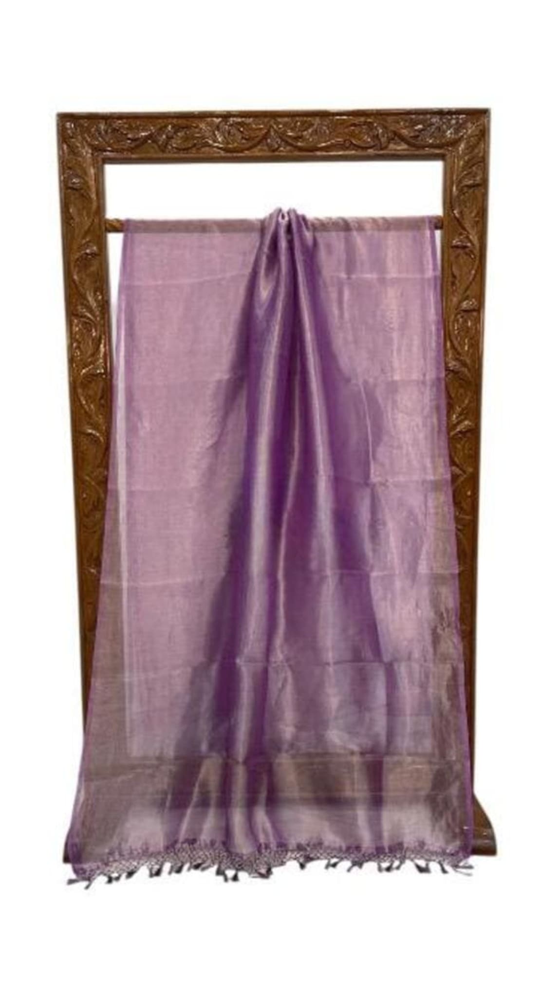 Purple sheer Banarasi saree laid flat with pleated center, zari border and tassel fringe
