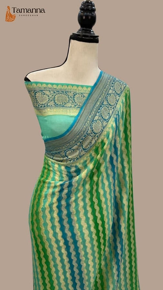 Green saree draped on mannequin, teal body with blue patterned pallu border