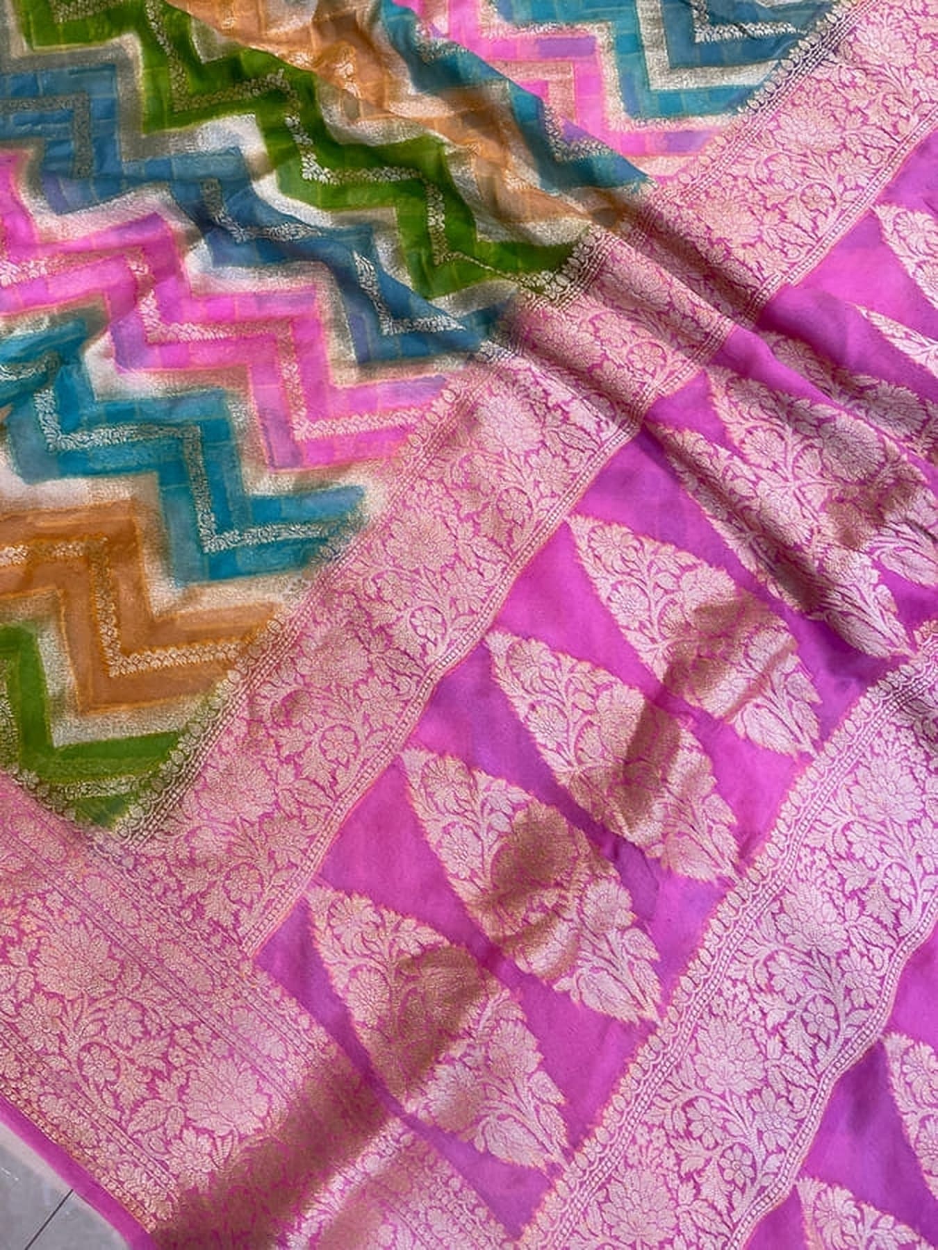 Purple saree pallu with gold floral zari work and green-blue zigzag trim