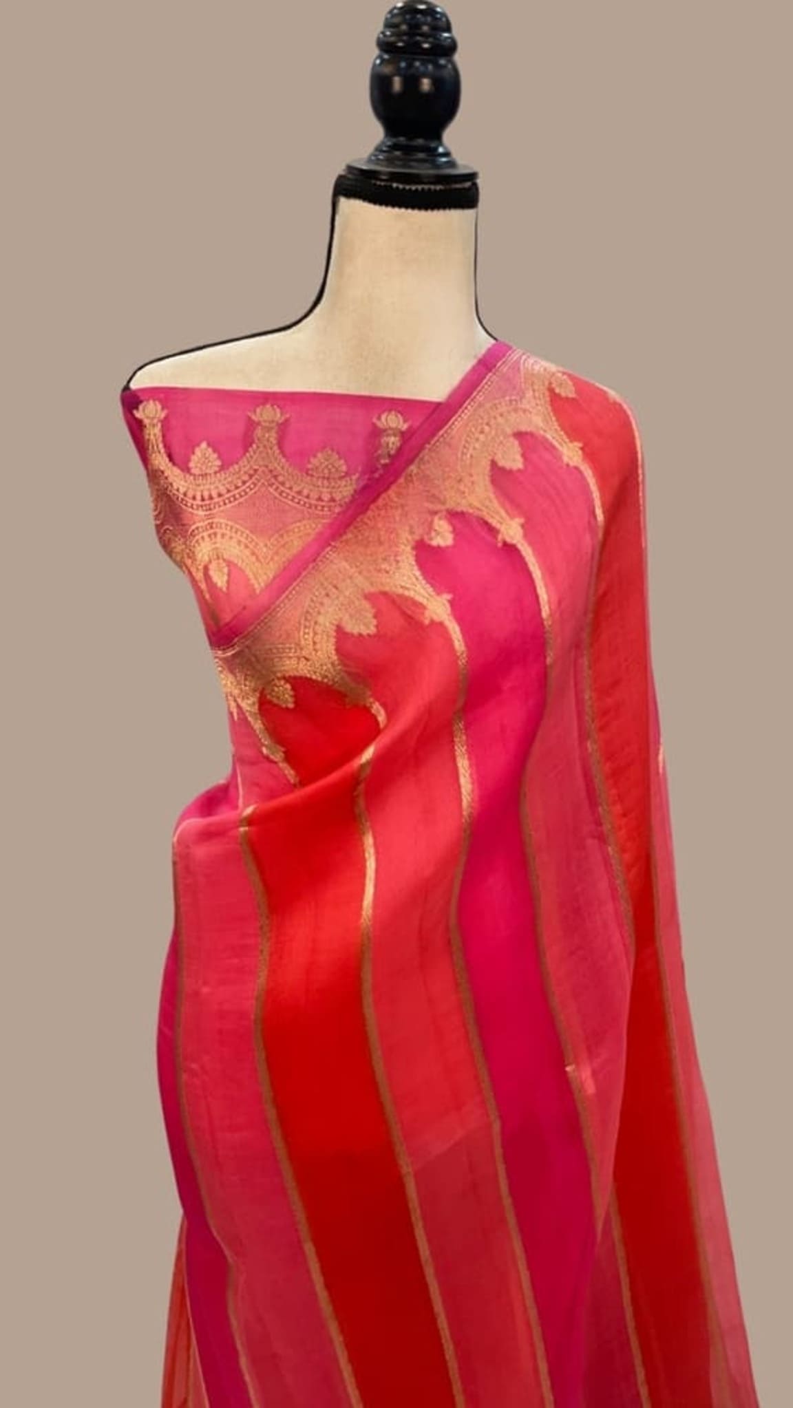 Pink Banarasi saree on mannequin, gold motifs and zari border pallu
