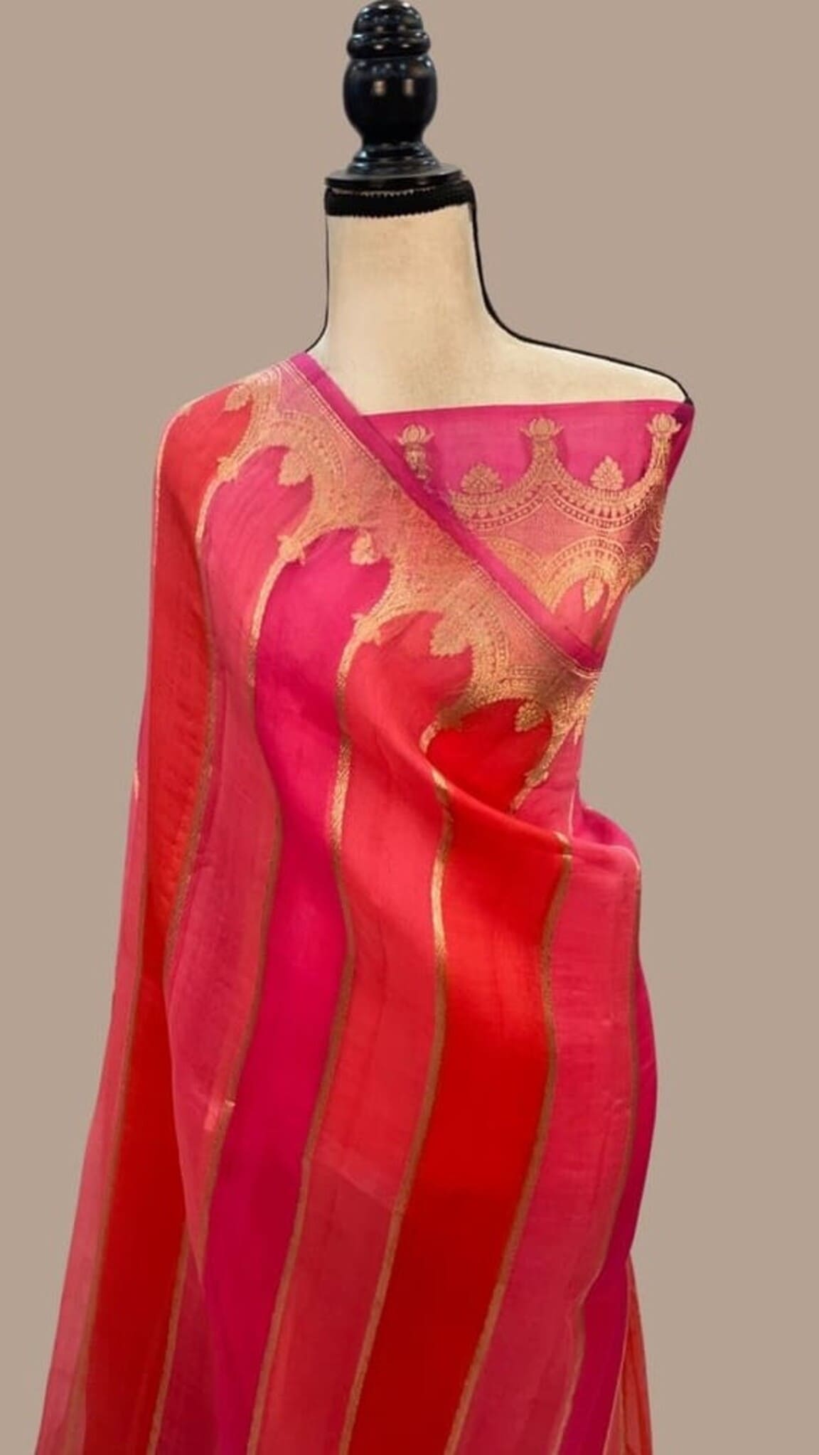 Pink Banarasi saree draped on mannequin, gold motif pallu and striped body
