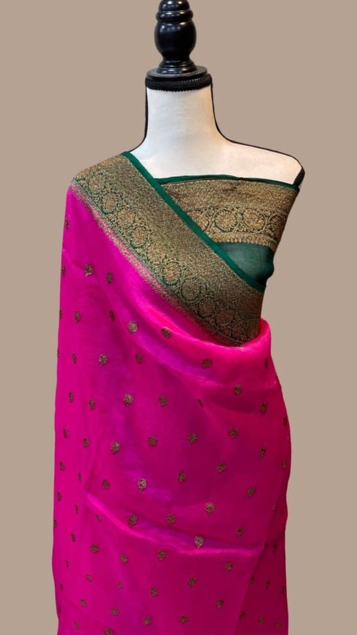 Bright pink Banarasi saree with tiny gold motifs, dark green border and patterned pallu