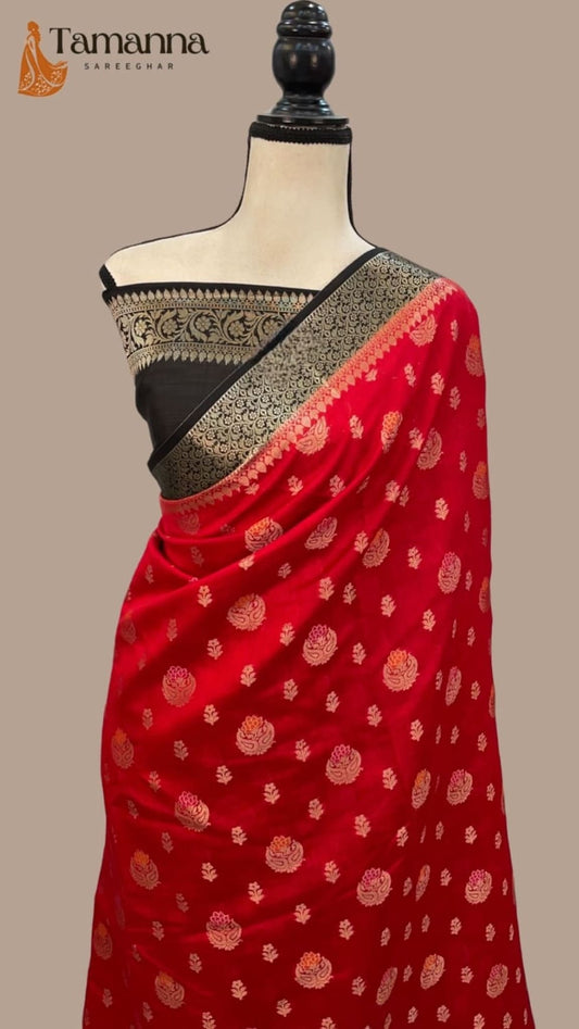 Red silk saree with black border and small gold motifs, draped on mannequin