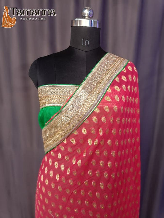 Red saree drape on mannequin, gold zari border with green trim and motifs
