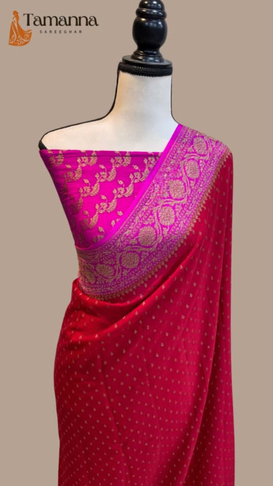 Red saree with contrast magenta pallu and ornate gold zari work on the drape