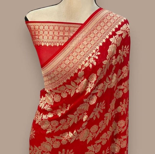 Red saree drape with gold zari edging and dense floral motif pattern on body