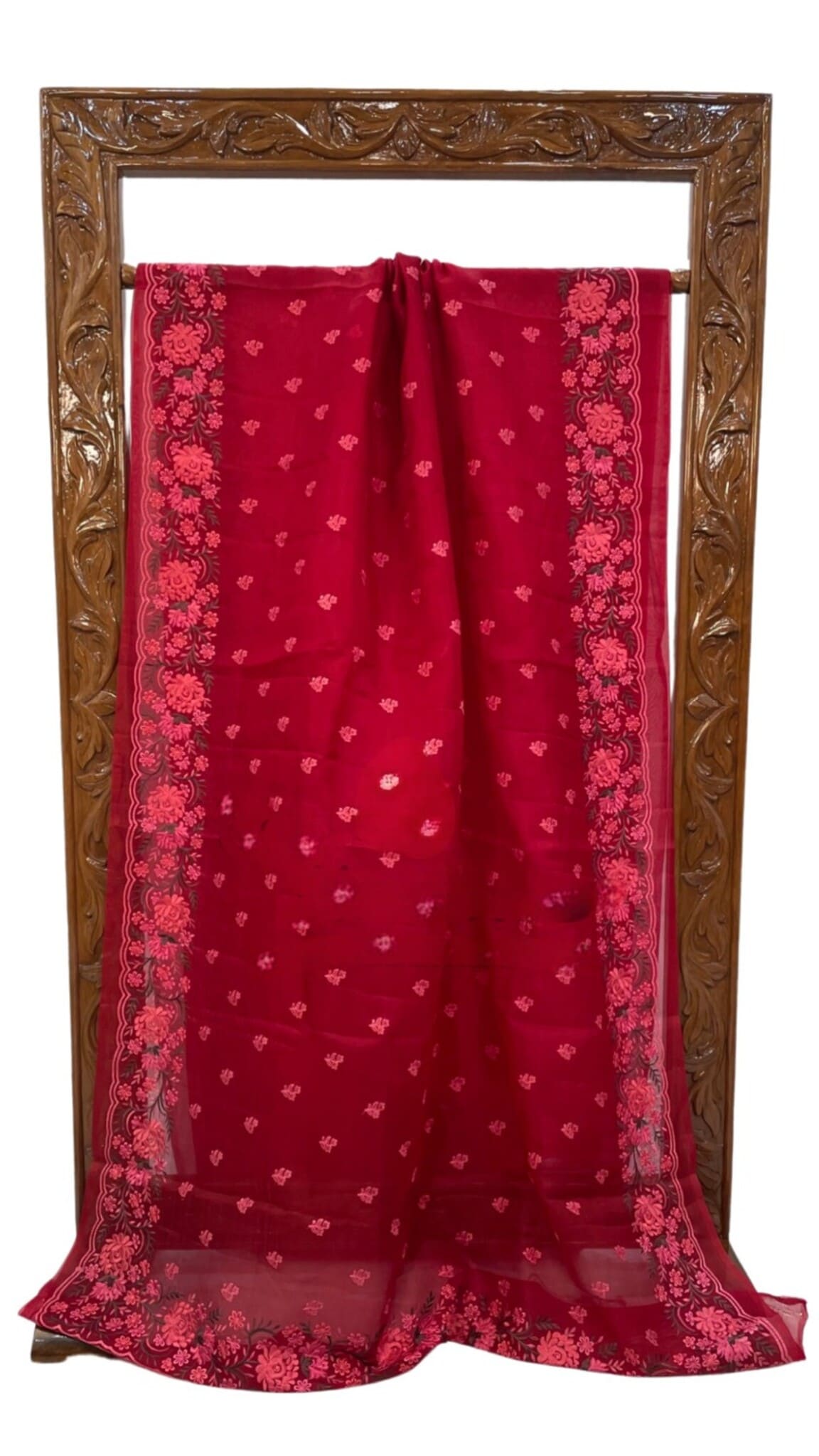Red organza saree folded display with pink lace-like border and allover buti motifs