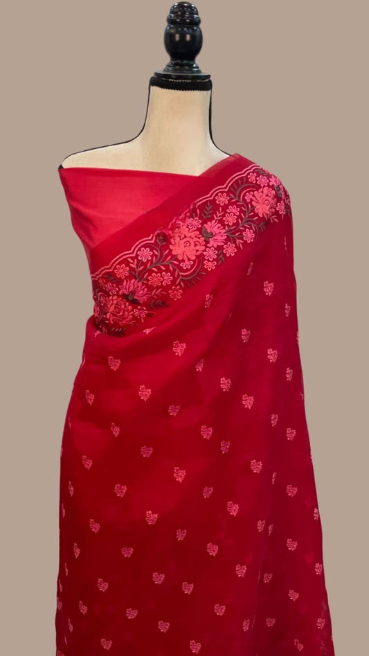 Red organza saree with pink embroidered border and scattered buti motifs