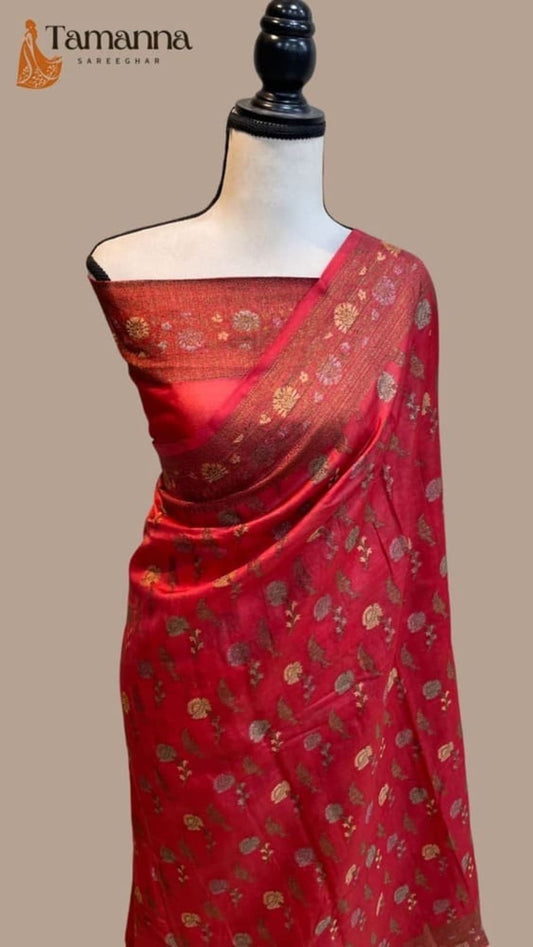 Red Banarasi-style saree draped on mannequin, gold motif allover and gold border
