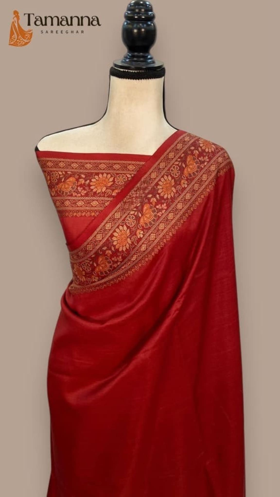 Red crepe Banarasi saree on mannequin with patterned gold-toned pallu border