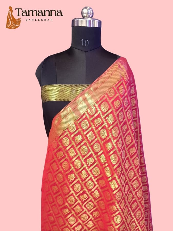 Red chiffon saree draped on mannequin, gold zari border with geometric motifs