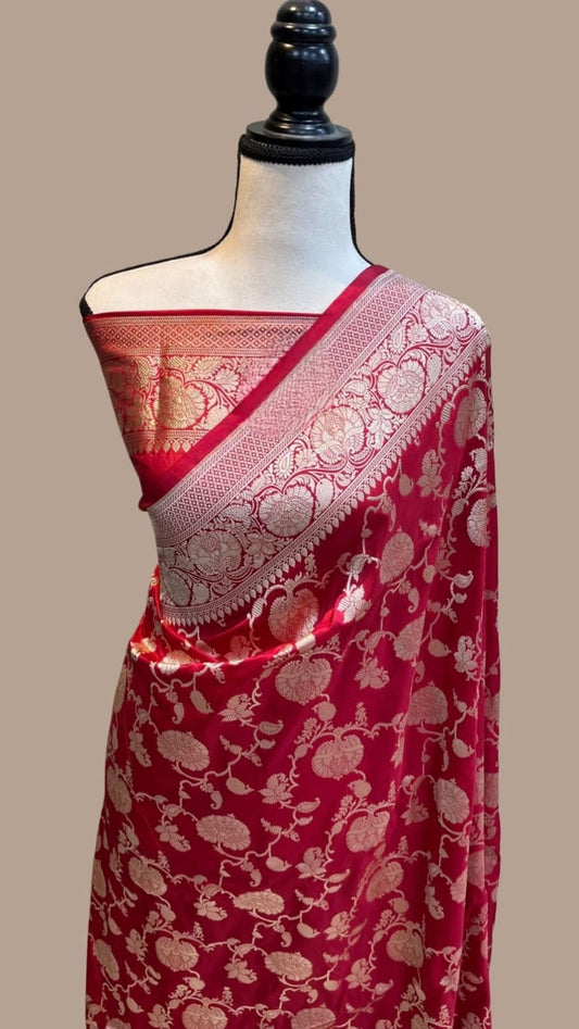 Red silk Banarasi saree on mannequin with gold zari border and patterned pallu