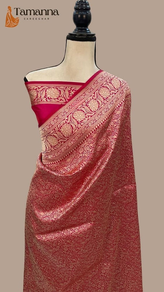 Red Banarasi silk saree with wide brocade pallu and zari border on mannequin