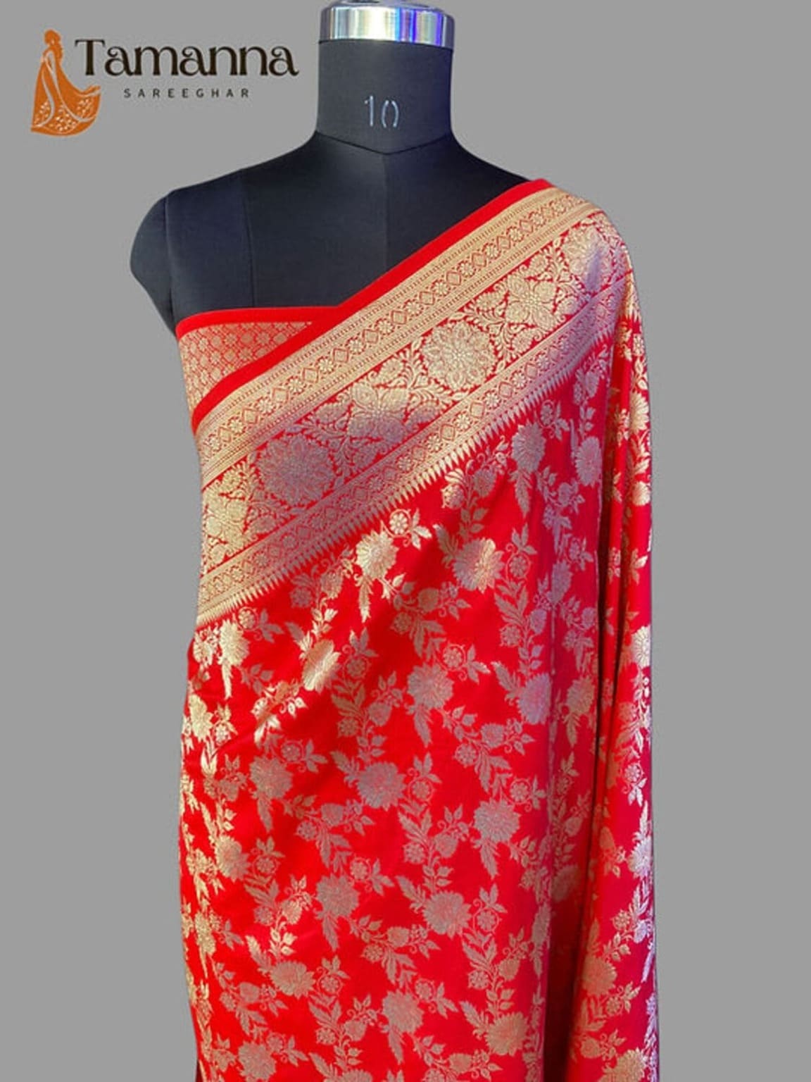 Red silk saree with gold zari border and patterned pallu